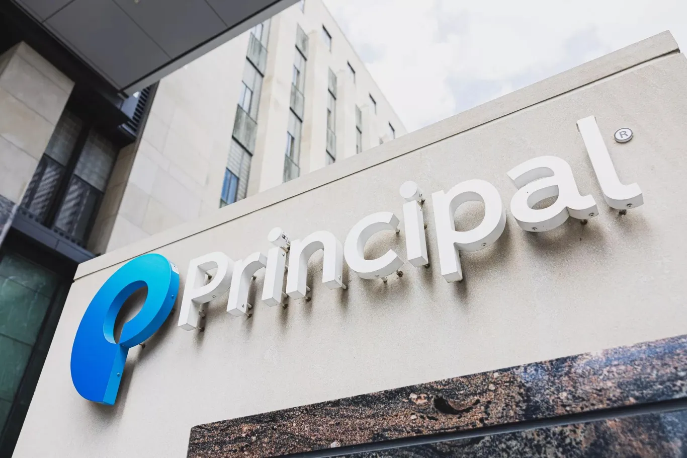 An upward view of the Principal Financial Group campus exterior signage.
